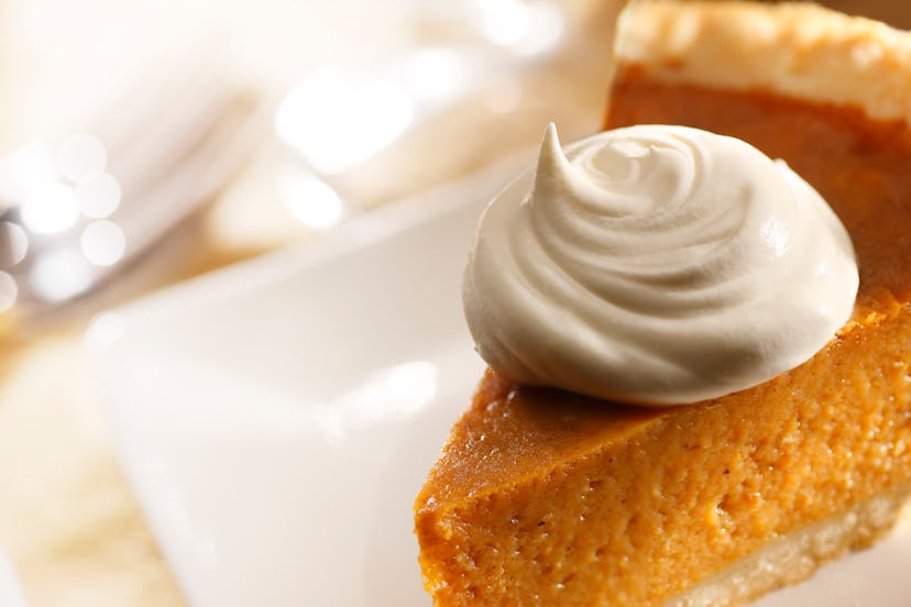 A dollop of whipped cream on a slice of pumpkin pie best wine with pumpkin pie and pumpkin pie alcoh...