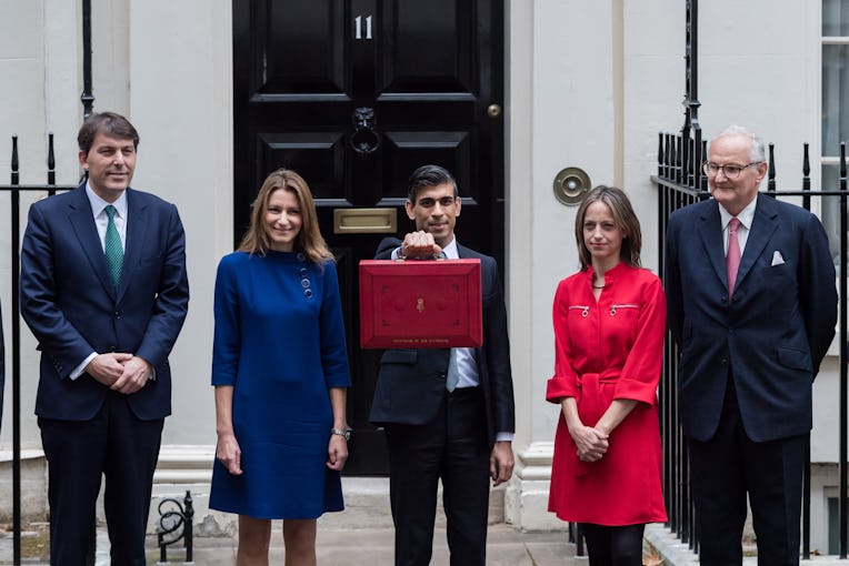 LONDON, UNITED KINGDOM - OCTOBER 27, 2021: Chancellor of the Exchequer Rishi Sunak (C) holds the Bud...