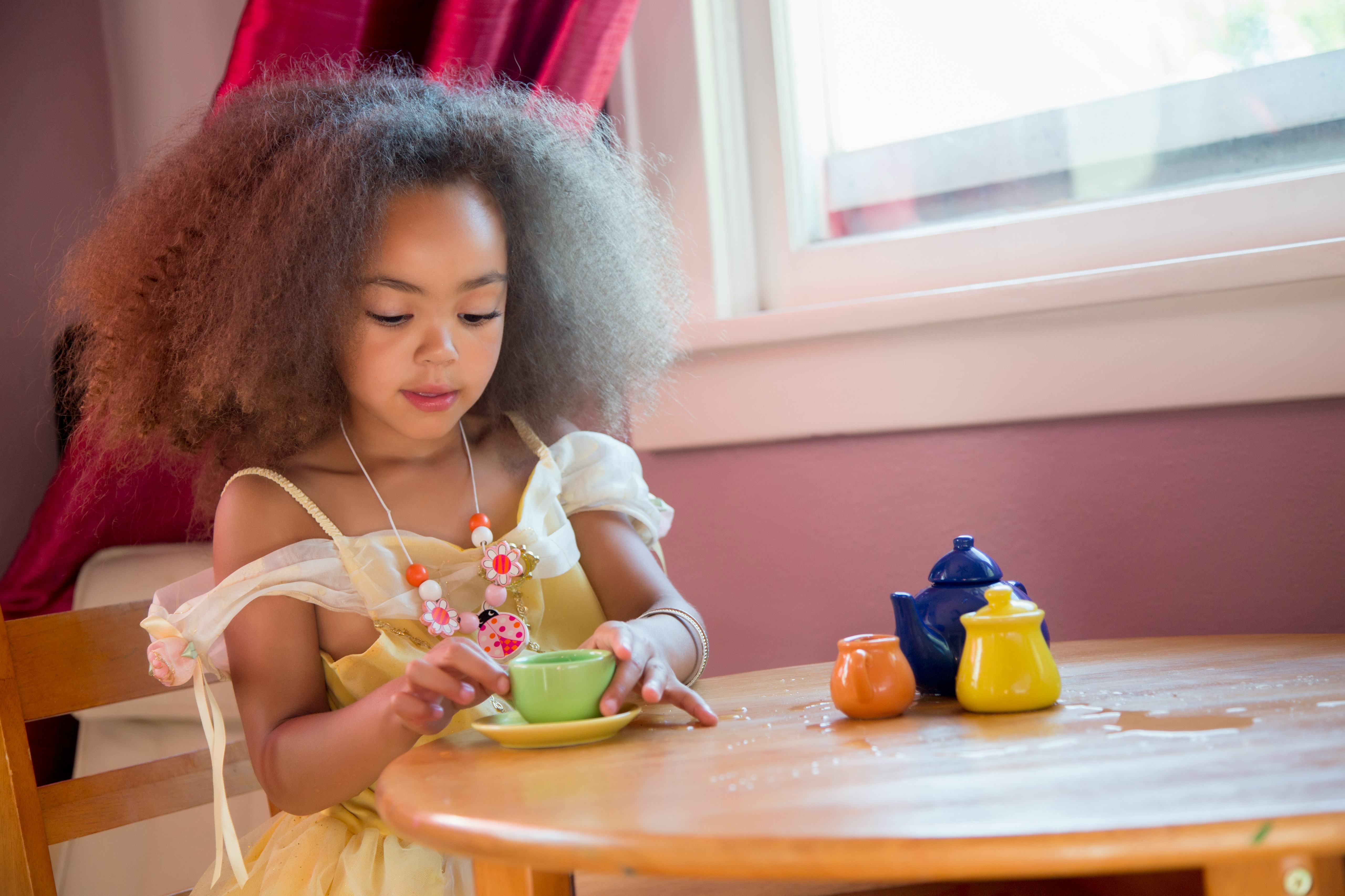 Little Girl Having A Tea Party With Her Imaginary Friends
