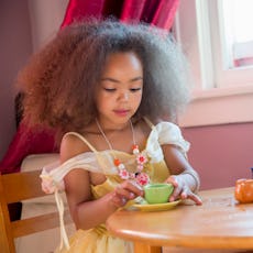 Little Girl Having A Tea Party With Her Imaginary Friends