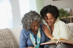 a mother-in-law looks at photos with her daughter-in-law in a round up of mother-in-law poems