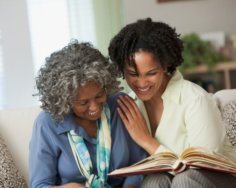 a mother-in-law looks at photos with her daughter-in-law in a round up of mother-in-law poems