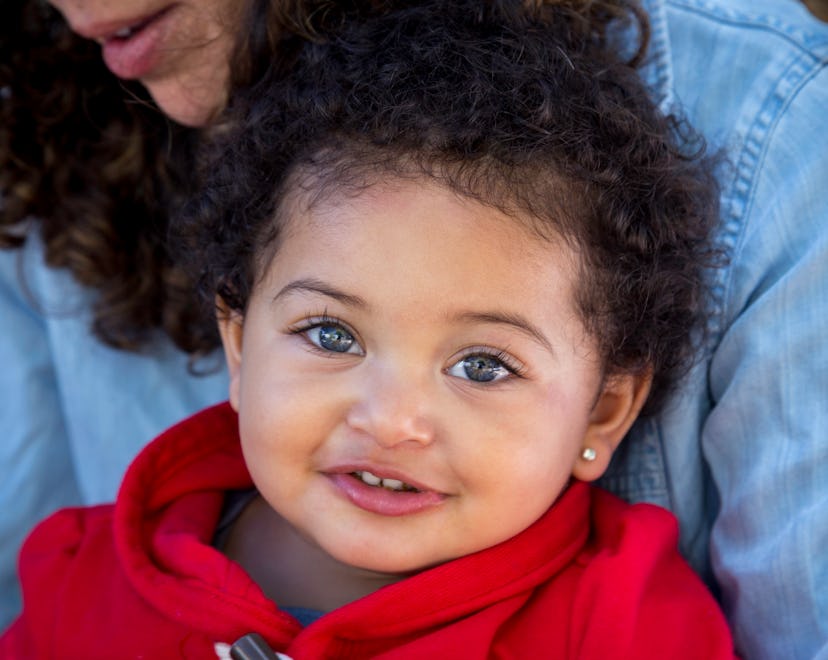 Beautiful 14-month-old smiling baby girl in article about I names for girls 