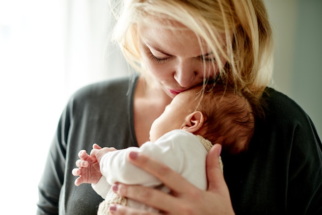 Photo of a mother spending time with her newborn in a roundup of baby boy names that start with...
