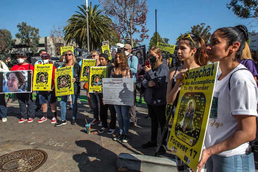 Family and friends of people who died after taking pills with fentanyl, hold signs as they protest a...