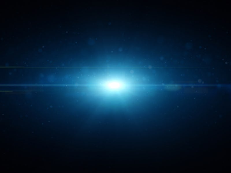 Flash Light and Glowing Particles against Dark Background