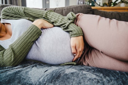 Pelvic pain during pregnancy can feel like cramping, muscle aches, or back pain.