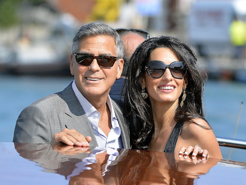 US actor George Clooney ( L) and his Lebanon-born British fiancee Amal Alamuddin take a taxiboat upo...