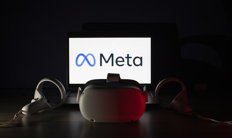 The logo of "Meta" displayed on computer screen behind the VR headset in Ankara