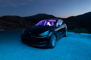 A black 2020 Tesla Model Y car in the mountains of Utah after dusk with interesting interior/exterio...