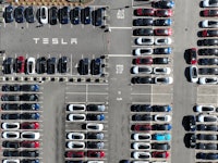 FREMONT, CALIFORNIA - OCTOBER 19: In an aerial view, brand new Tesla cars sit in a parking lot at th...