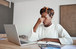 Shot of a young woman looking stressed out while working on a laptop
