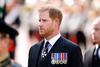 Prince Harry, Duke of Sussex walks behind Queen Elizabeth II's coffin as it is transported on a gun ...