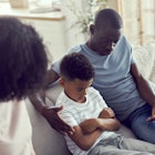 Discontented annoyed African parents scold their preschooler little son for bad behaviour or miscond...
