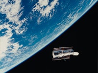 The Hubble Space Telescope (HST) floats gracefully above the Earth following its release from the Sp...