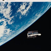 The Hubble Space Telescope (HST) floats gracefully above the Earth following its release from the Sp...