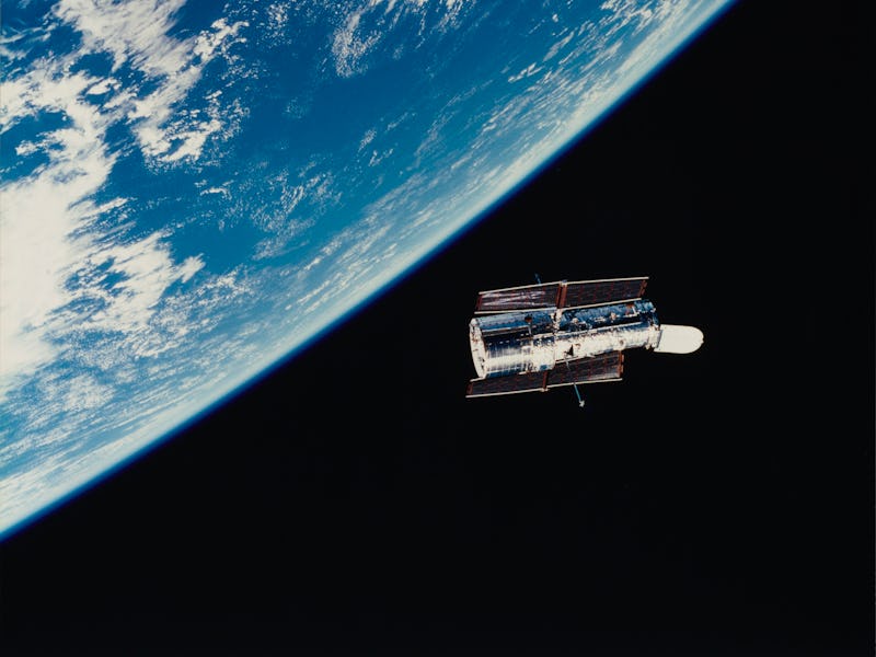 The Hubble Space Telescope (HST) floats gracefully above the Earth following its release from the Sp...