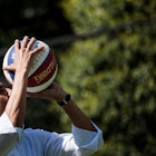 US President Barack Obama shoots a basketball while participating in a basketball station with the H...