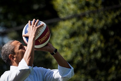 US President Barack Obama shoots a basketball while participating in a basketball station with the H...