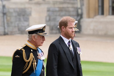 Britain's King Charles III (L) walks with his son Britain's Prince Harry, Duke of Sussex as they arr...