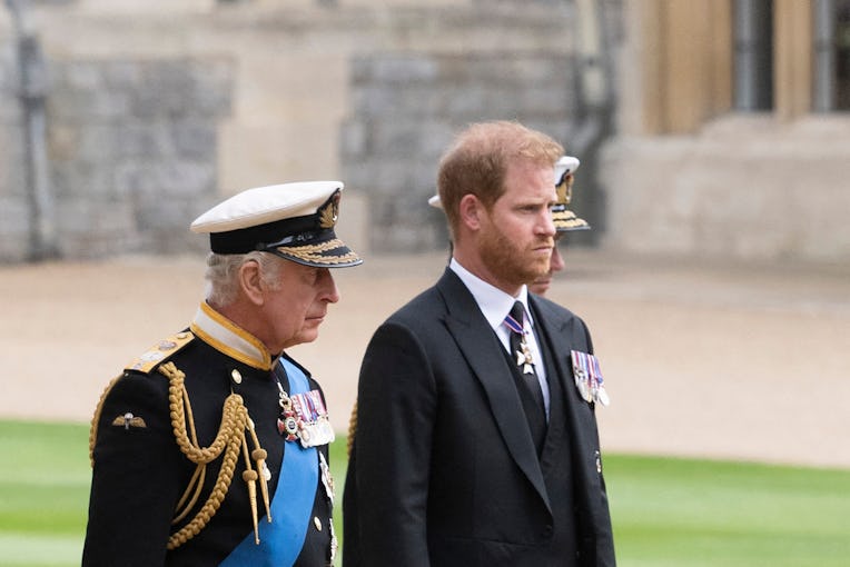 Britain's King Charles III (L) walks with his son Britain's Prince Harry, Duke of Sussex as they arr...