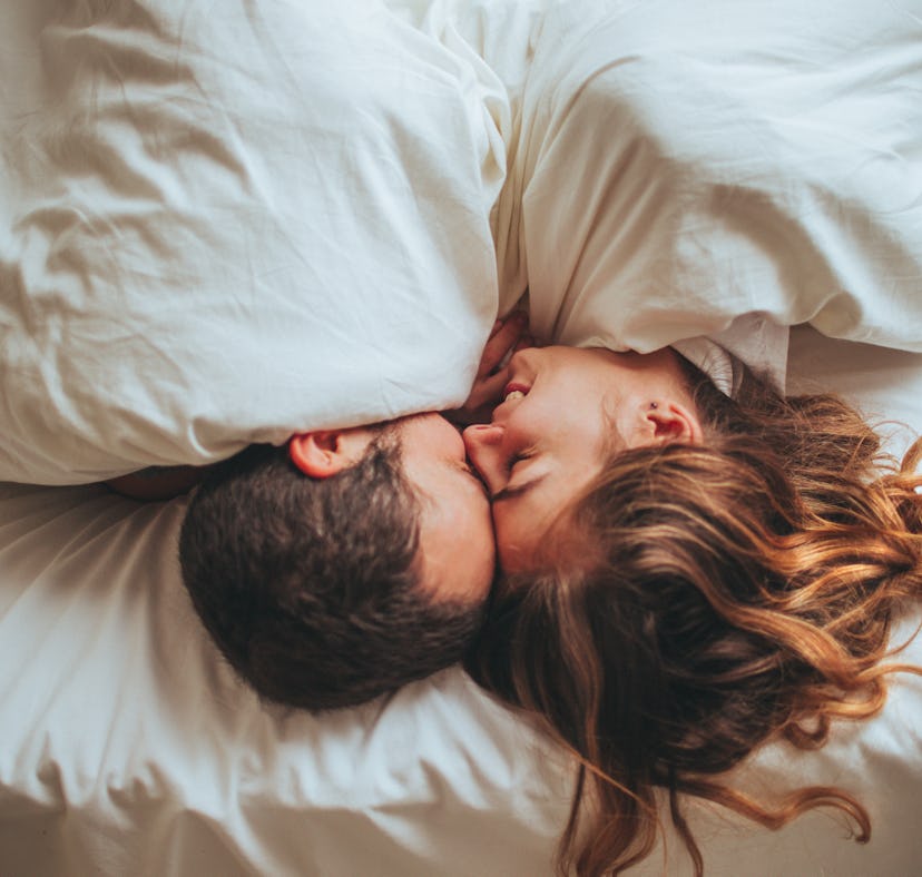 Couple in bed trying new kinks to spice up their sex life.