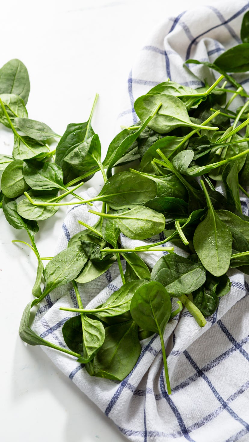 Organic spinach baby leaves on kitchen towel, healthy food