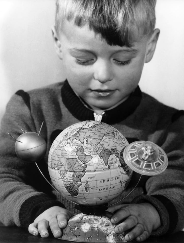 Little Moritz plays Sputnik's space journey with his toy (picture taken in 1957). A satellite and a ...
