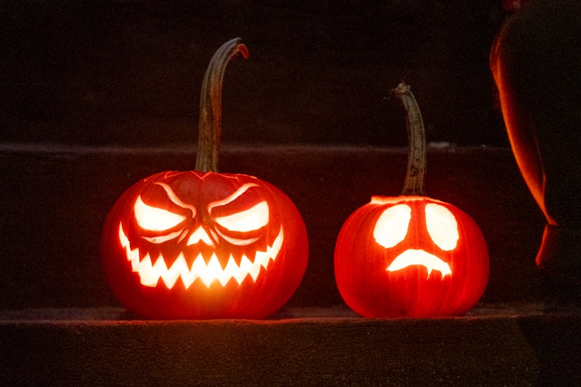 A house is decorated with Jack o' Lanterns in celebration of Halloween in an article about Halloween...