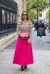 Wearing fall 2022 fashion trends for yellow auras, Maria Rosaria Rizzo wears pink skirt, striped jum...