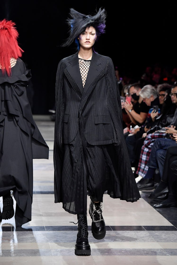 A model in Junya Watanabe black maxi skirt and oversized black blazer at Paris Fashion Week Spring 2...