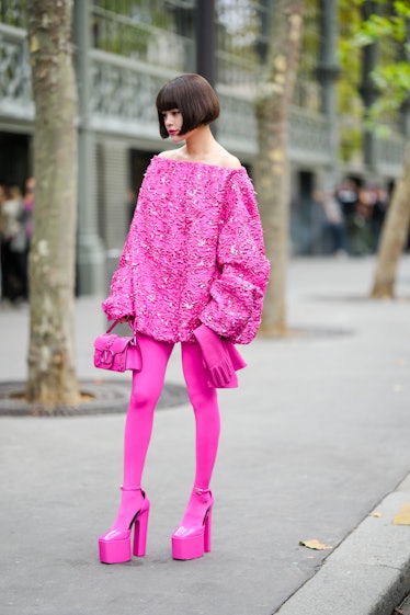 Wearing fall 2022 fashion trends for violet auras, a guest wears a neon pink embroidered sequined sh...