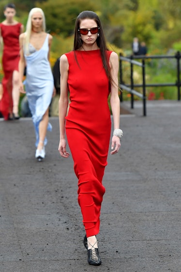 A model in Givenchy maxi skintight red simple dress at Paris Fashion Week Spring 2023