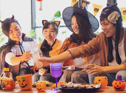 Group of friends on Halloween, including one woman in a cat Halloween costume, for which she'll want...