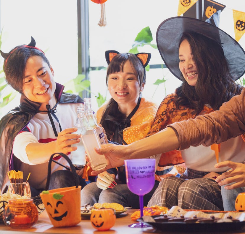 Group of friends on Halloween, including one woman in a cat Halloween costume, for which she'll want...
