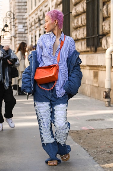 Wearing fall 2022 fashion trends for magenta auras, a guest is seen wearing a blue striped shirt, bl...