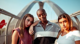 Three friends pose for a photo together as they reflect on how the October 2022 blood moon will affe...