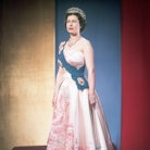 Queen Elizabeth II wearing the crown jewels, dressed for a formal occasion. She wears her family's o...