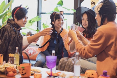 Group of friends on Halloween, including one woman in a cat Halloween costume, for which she'll want...
