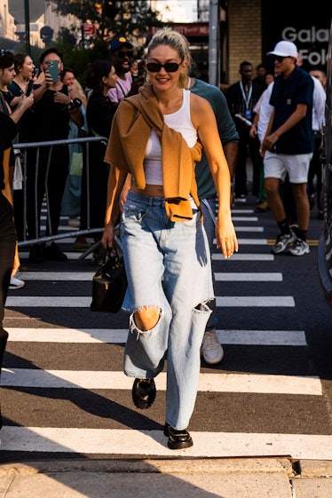 Wearing fall fashion trends for blue auras, Gigi Hadid attends the Vogue World fashion show during N...