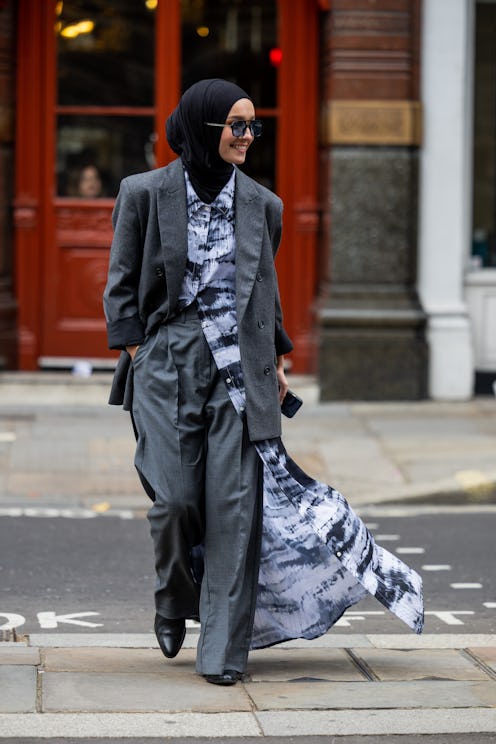 LONDON, ENGLAND - SEPTEMBER 18: A guest wears grey oversized blazer, pants, button up shirt outside ...