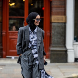 LONDON, ENGLAND - SEPTEMBER 18: A guest wears grey oversized blazer, pants, button up shirt outside ...