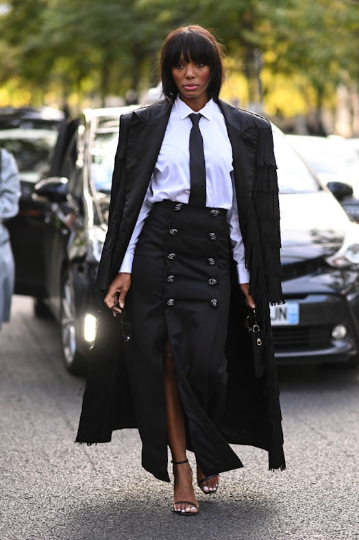 PARIS, FRANCE - SEPTEMBER 28: A guest is seen wearing a black coat, white shirt, black tie and black...