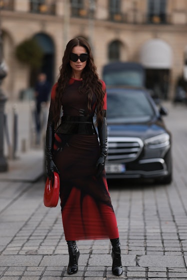 Wearing fall 2022 fashion trends for red auras, Sabina Jakubowicz seen wearing a Loewe dress with a ...