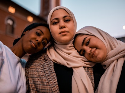 three young women pose for a photo as they all discuss how they will be the most affected by the oct...