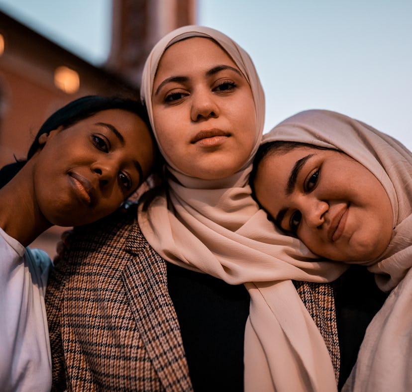 three young women pose for a photo as they all discuss how they will be the most affected by the oct...
