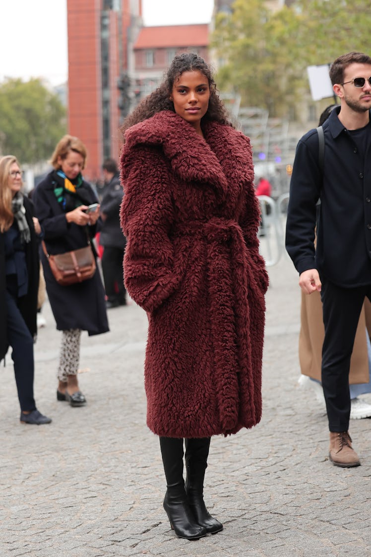 Wearing fall 2022 fashion trends for magenta auras, Tina Kunakey attends the Stella McCartney Womens...