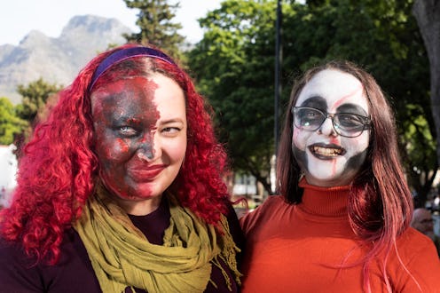Participants pose for photos as they join hundreds of people taking part in the Cape Town Zombie Wal...