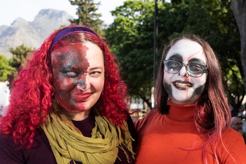 Participants pose for photos as they join hundreds of people taking part in the Cape Town Zombie Wal...
