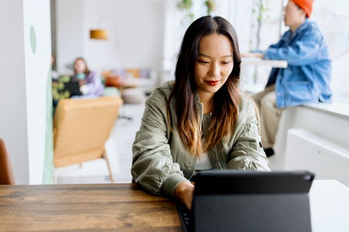 Young businesswoman using a digital tablet while at work